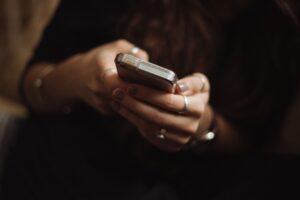 Woman on phone searching for a place to get a free pregnancy test